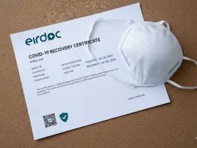 COVID Recovery Certificate on the table and also mask is on the certificate